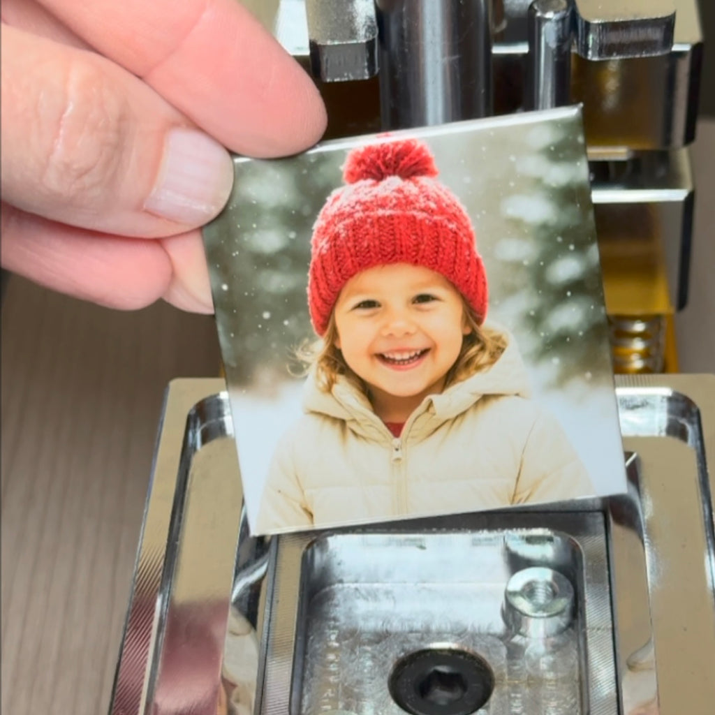 2x2 square custom photo magnet with child wearing red knit hat during pressing