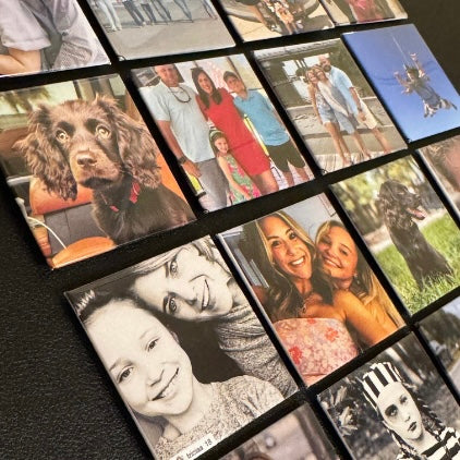 Set of nine 2x2 square custom photo magnets displayed on a table